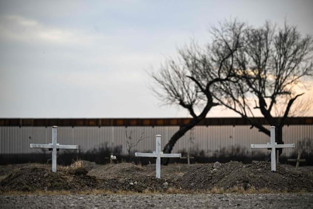 Crosses mark the graves of migrants at a cemetery adjacent to the US-Mexico border wall in Quemado, Texas, on February 18, 2026. (Photo by RONALDO SCHEMIDT / AFP)