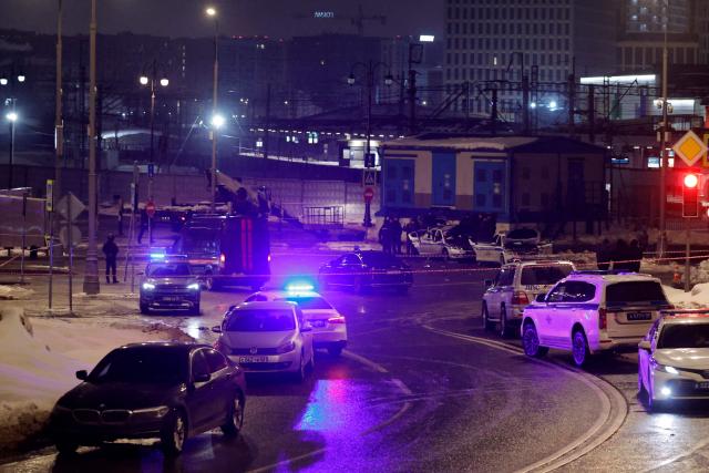 Russian law enforcement officers work at the site of a police car explosion in Moscow on February 24, 2026. A man detonated an explosive device beside a police patrol car in central Moscow early on February 24, 2026, killing one officer and wounding two others, the Russian interior ministry said. (Photo by TATYANA MAKEYEVA / AFP)