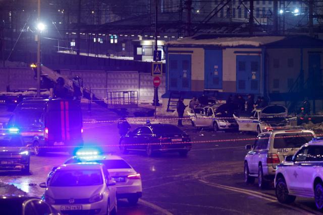 Russian law enforcement officers work at the site of a police car explosion in Moscow on February 24, 2026. A man detonated an explosive device beside a police patrol car in central Moscow early on February 24, 2026, killing one officer and wounding two others, the Russian interior ministry said. (Photo by TATYANA MAKEYEVA / AFP)