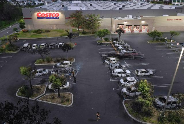Aerial view of burned cars in the parking lot of a Costco retail store in Puerto Vallarta, Jalisco state, Mexico, on February 23, 2026. Mexico has deployed 10,000 troops to quell clashes sparked by the killing of the country's most wanted drug lord, which have left dozens dead, officials said on February 23. Nemesio "El Mencho" Oseguera, leader of the Jalisco New Generation Cartel (CJNG), was wounded on February 22 in a shootout with soldiers in the town of Tapalpa in Jalisco state and died while being flown to Mexico City, the army said. (Photo by Alfredo ESTRELLA / AFP)
