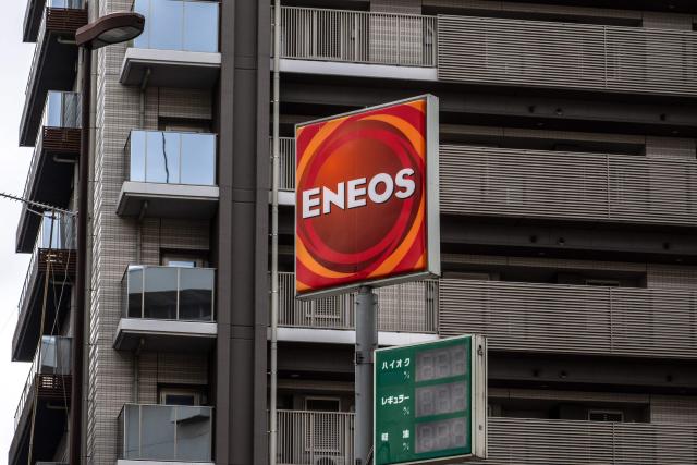 A logo of Japanese petroleum company ENEOS Corporation is pictred at the company's gas station in Tokyo's Koto district on February 24, 2026. China's commerce ministry took action against 40 Japanese companies and entities on February 24, 2026, citing national security concerns over their military ties. (Photo by Philip FONG / AFP)