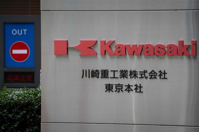 The logo of Kawasaki Heavy Industries is seen outside the company’s headquarters in Tokyo on February 24, 2026. China's commerce ministry took action against 40 Japanese companies and entities on February 24, 2026, citing national security concerns over their military ties. (Photo by Yuichi YAMAZAKI / AFP)