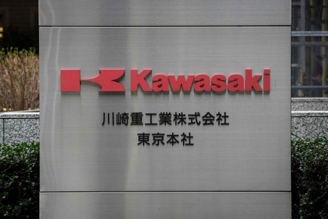 The logo of Kawasaki Heavy Industries is seen outside the company’s headquarters in Tokyo on February 24, 2026. China's commerce ministry took action against 40 Japanese companies and entities on February 24, 2026, citing national security concerns over their military ties. (Photo by Yuichi YAMAZAKI / AFP)