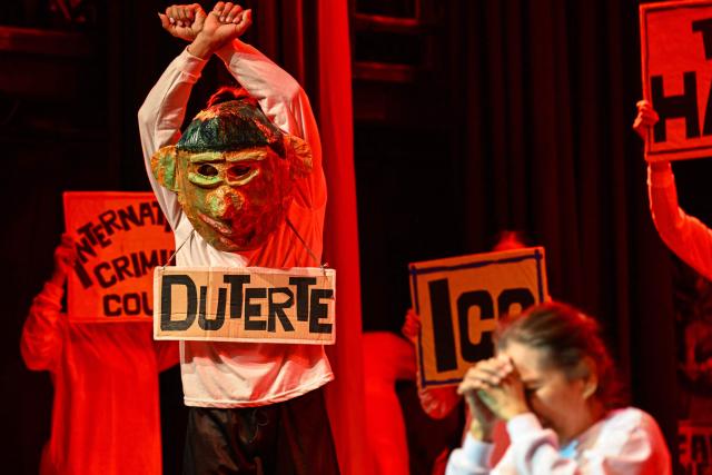 Relatives of the victims of extrajudicial killings of former Philippine president Rodrigo Duterte's drug war, perform a theatre play called “Teatro Paghilom”, a holistic program that aims to help the widows and orphans of extrajudicial killings victims rebuild and re-create their lives, at a university in Manila on February 24, 2026. The International Criminal Court (ICC) opened hearings on February 23, to decide whether former Philippine president Rodrigo Duterte should stand trial for crimes against humanity linked to his deadly anti-drug crackdown. (Photo by Jam STA ROSA / AFP)