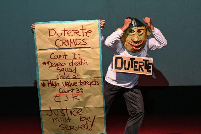 Relatives of the victims of extrajudicial killings of former Philippine president Rodrigo Duterte's drug war, perform a theatre play called “Teatro Paghilom”, a holistic program that aims to help the widows and orphans of extrajudicial killings victims rebuild and re-create their lives, at a university in Manila on February 24, 2026. The International Criminal Court (ICC) opened hearings on February 23, to decide whether former Philippine president Rodrigo Duterte should stand trial for crimes against humanity linked to his deadly anti-drug crackdown. (Photo by Jam STA ROSA / AFP)