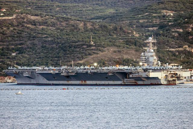 The US aircraft carrier USS Gerald Ford is pictured docked at Souda Bay in the Mediterranean island of Crete, Greece, on February 24, 2026. Upon military orders by US President Donald Trump, the world's largest vessel is on its way to the Middle East to join 13 more warships stationed in the region: the aircraft carrier USS Abraham Lincoln, which arrived late last month, nine destroyers and three frigates. (Photo by Costas METAXAKIS / AFP)