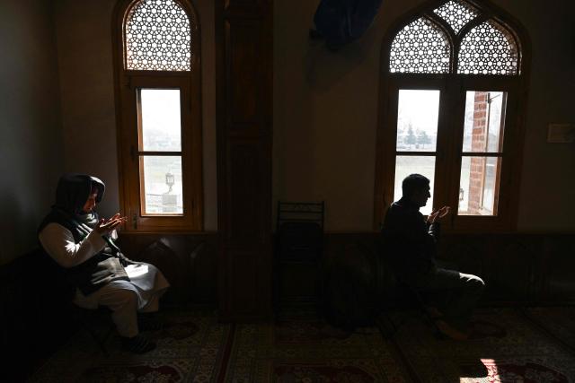 Muslim devotees offer prayers during the Islamic holy fasting month of Ramadan, at a mosque in Srinagar on February 24, 2026. (Photo by Tauseef MUSTAFA / AFP)
