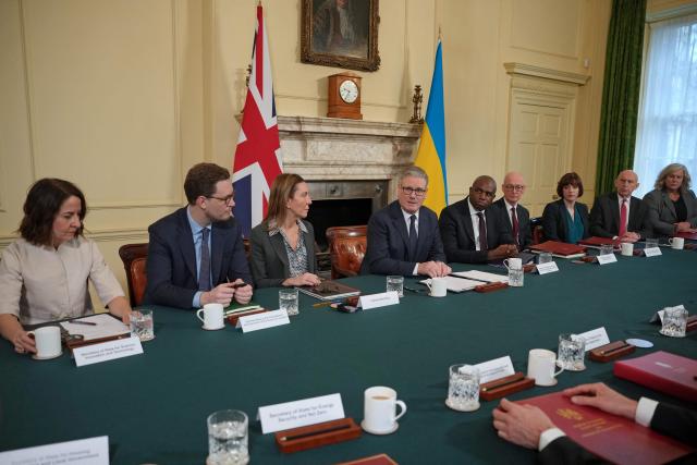 Britain's Prime Minister Keir Starmer, flanked by Britain's Science, Innovation and Technology Secretary Liz Kendall (L), Chancellor of the Duchy of Lancaster and Chief Secretary to the Prime Minister Darren Jones (2L), Cabinet Secretary Antonia Romeo (3L), Britain's Justice Secretary and Deputy Prime Minister David Lammy (5R), Britain's Pensions Secretary Pat McFadden (4R), and Britain's Education Secretary Bridget Phillipson (3R), Britain's Defence Secretary John Healey (2R) and Britain's Transport Secretary Heidi Alexander as he delivers remarks at the top of a Cabinet meeting inside 10 Downing Street in London, on February 24, 2026, to mark the fourth anniversary of Russia's full-scale invasion of Ukraine. (Photo by Kin Cheung / POOL / AFP)