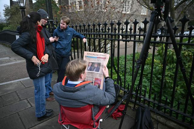 A member of the media reads a copy of the Financial Times newspaper, with the front page story leading on the arrest of former UK ambassador to the United States, Peter Mandelson, as they wait outside of Mandelson's home in central London on February 24, 2026, the morning after he was arrested on "suspicion of misconduct in public office". London police later released former ambassador Peter Mandelson on bail in the early hours of February 24, in a probe into his ties to disgraced US financier Jeffrey Epstein, only days after ex-prince Andrew was arrested. (Photo by JUSTIN TALLIS / AFP)