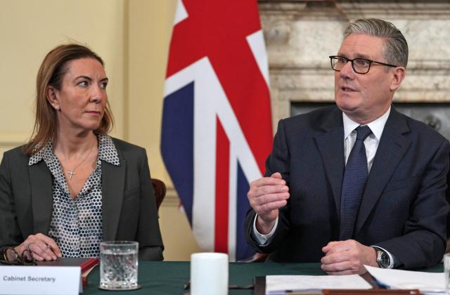 Britain's Prime Minister Keir Starmer, flanked by newly appointed Cabinet Secretary Antonia Romeo (L), delivers remarks at the top of a Cabinet meeting inside 10 Downing Street in London, on February 24, 2026, to mark the fourth anniversary of Russia's full-scale invasion of Ukraine. (Photo by Kin Cheung / POOL / AFP)
