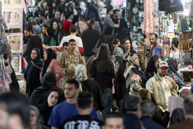Iranians shop at Tehran's Grand Bazaar on February 24, 2026. Iran warned the United States on February 23, 2026, that any attack would be met "ferociously" in response to the US president's threat of limited strikes. The United States has built up forces in the Middle East to pile pressure on Iran to make a deal at negotiations due to restart on February 26, with the US president weighing a limited strike if no agreement is reached. (Photo by AFP)