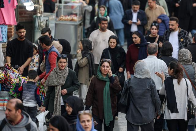Iranians shop at Tehran's Grand Bazaar on February 24, 2026. Iran warned the United States on February 23, 2026, that any attack would be met "ferociously" in response to the US president's threat of limited strikes. The United States has built up forces in the Middle East to pile pressure on Iran to make a deal at negotiations due to restart on February 26, with the US president weighing a limited strike if no agreement is reached. (Photo by AFP)