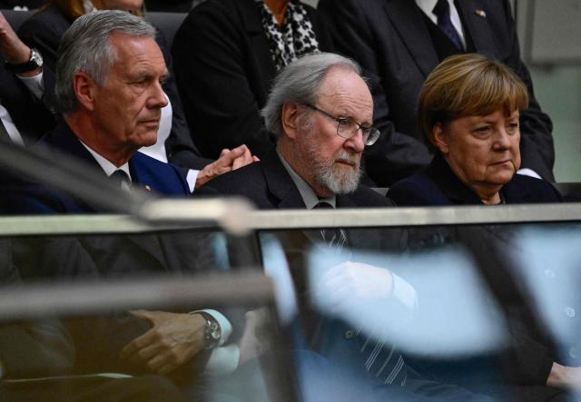 (L-R) Member of Germany's Christian Democratic Union (CDU) and former German President Christian Wulff, former German Bundestag President Wolfgang Thierse and former German chancellor Angela Merkel attend a commemoration ceremony for late former Bundestag President Rita Suessmuth at the Bundestag (lower house of parliament) in Berlin, on February 24, 2026. (Photo by John MACDOUGALL / AFP)