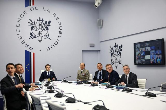 French President Emmanuel Macron (C-L) participates in a video-conference meeting of Ukraine's 'Coalition of the Willing', co-chaired by him and British Prime Minister Keir Starmer (not pictured), at the Elysee Presidential Palace in Paris on February 24, 2026. (Photo by Sarah Meyssonnier / POOL / AFP)