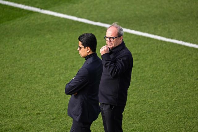 Paris Saint Germain's Portuguese Football Advisor Luis Campos (R) talks with Paris Saint Germain's Qatari president Nasser Al-Khelaifi during a training session at the Campus Paris Saint-Germain in Poissy, in the western outskirts of Paris on February 24, 2026, on the eve of the UEFA Champions League play-off second leg football match between Paris Saint-Germain and AS Monaco. (Photo by Anna KURTH / AFP)