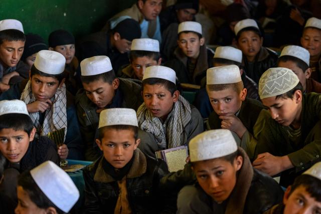Afghan boys attend a madrassa, or Islamic school, during the holy fasting month of Ramadan in the Faizabad district of Badakhshan province on February 24, 2026. (Photo by Omer ABRAR / AFP)