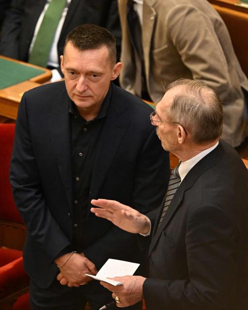 Member of the Hungarian Parliament, Chief of Staff of Hungary's Prime Minister Antal Rogan talks with Hungary's Minister of Interior Sandor Pinter in the main hall of the parliament building during the spring session of the Hungarian Parliament on February 23, 2026 in Budapest, Hungary. Hungarian Prime Minister Viktor Orban is facing the toughest challenge since returning to power in 2010, with his Fidesz party trailing the opposition TISZA party in opinion polls ahead of parliamentary elections on April 12, 2026. (Photo by Attila KISBENEDEK / AFP)