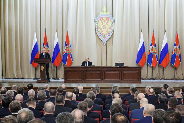 In this pool photograph distributed by the Russian state agency Sputnik, Russia's President Vladimir Putin (L) gives a speech during a meeting of the Federal Security Service Board in Moscow on February 24, 2026. (Photo by Mikhail METZEL / POOL / AFP)