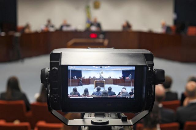 View of a camera filming the plenary session of the first chamber of the Brazilian Supreme Court during the first session of the trial of those suspected of ordering the assassination of Brazilian councilwoman Marielle Franco in 2018, at the Supreme Federal Court in Brasília, on February 24, 2026. (Photo by Sergio Lima / AFP)