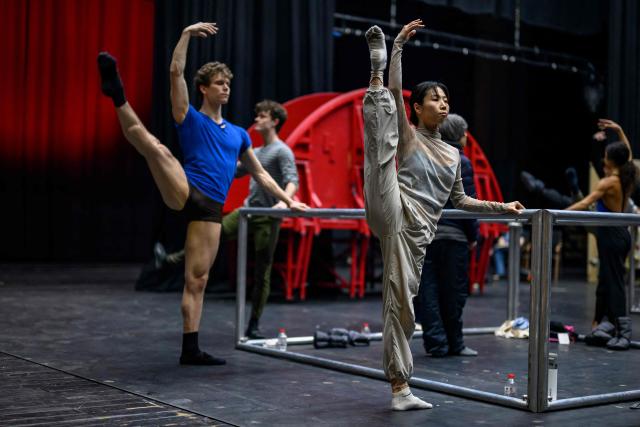 Dancers of the 'Bejart Ballet Lausanne' (BBL) of Switzerland, dance during a training session on the sidelines of the three unique ballets brought together at Zorlu Performing Arts Center (PSM) in Istanbul on February 20, 2026. Thirty-six dancers with raised arms glide slowly forward as they encircle their prey, a lone figure on a red table in a climactic scene from Ravel's "Bolero" choreographed by Maurice Bejart. (Photo by Yasin AKGUL / AFP)