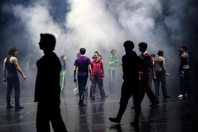Dancers of the 'Bejart Ballet Lausanne' (BBL) of Switzerland, dance during a rehearsal without costumes ahead of the three unique ballets brought together at Zorlu Performing Arts Center (PSM) in Istanbul on February 20, 2026. Thirty-six dancers with raised arms glide slowly forward as they encircle their prey, a lone figure on a red table in a climactic scene from Ravel's "Bolero" choreographed by Maurice Bejart. (Photo by Yasin AKGUL / AFP)
