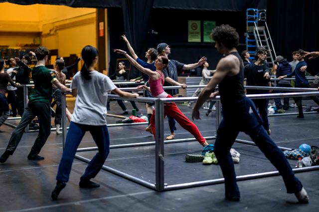 Dancers of the 'Bejart Ballet Lausanne' (BBL) of Switzerland, dance during a training session on the sidelines of the three unique ballets brought together at Zorlu Performing Arts Center (PSM) in Istanbul on February 20, 2026. Thirty-six dancers with raised arms glide slowly forward as they encircle their prey, a lone figure on a red table in a climactic scene from Ravel's "Bolero" choreographed by Maurice Bejart. (Photo by Yasin AKGUL / AFP)