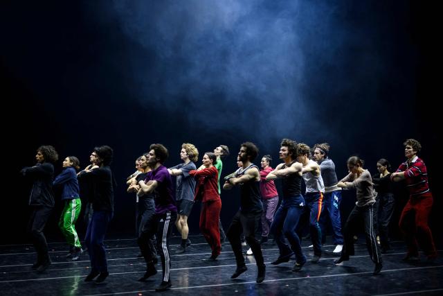 Dancers of the 'Bejart Ballet Lausanne' (BBL) of Switzerland, dance during a rehearsal without costumes ahead of the three unique ballets brought together at Zorlu Performing Arts Center (PSM) in Istanbul on February 20, 2026. Thirty-six dancers with raised arms glide slowly forward as they encircle their prey, a lone figure on a red table in a climactic scene from Ravel's "Bolero" choreographed by Maurice Bejart. (Photo by Yasin AKGUL / AFP)