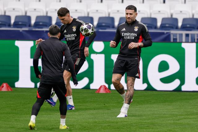 SL Benfica's Argentine defender #30 Nicolas Otamendi (R) kicks the ball during a training session on the eve of their UEFA Champions League knockout round play-off second leg football match against Real Madrid CF at Santiago Bernabeu Stadium in Madrid on February 24, 2026. (Photo by Oscar DEL POZO / AFP)
