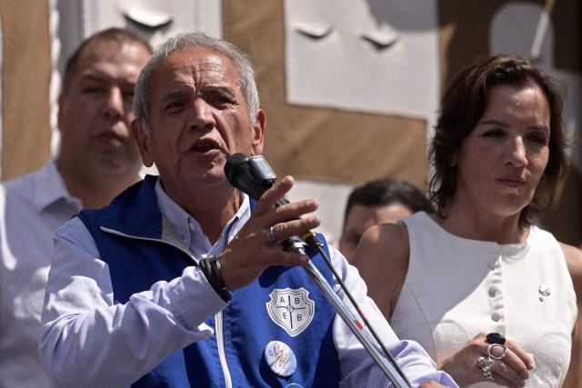 Sergio Palazzo (L) National Deputy for Buenos Aires province and leader of bank workers' union, speaks during a protest of judicial employees of labor courts against a labor reform promoted by Argentine President Javier Milei outside the courthouse in Buenos Aires on February 24, 2026. (Photo by JUAN MABROMATA / AFP)