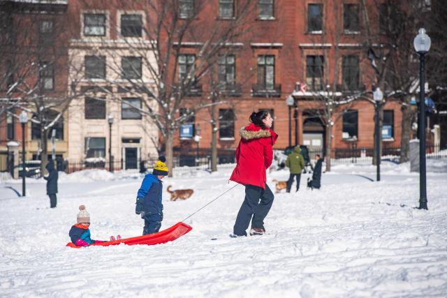 Families sled down the snow covered Flagstaff Hill in Boston Common in Boston, Massachusetts on February 24, 2026. More than 40 million people were under weather warnings in the northeastern United States, as a winter storm dumped shin-deep snow and officials enforced travel bans and school closures in several cities. The so-called "Nor'easter" pummeled the region, disrupting flights and leaving hundreds of thousands of homes and businesses without power. (Photo by Joseph Prezioso / AFP)