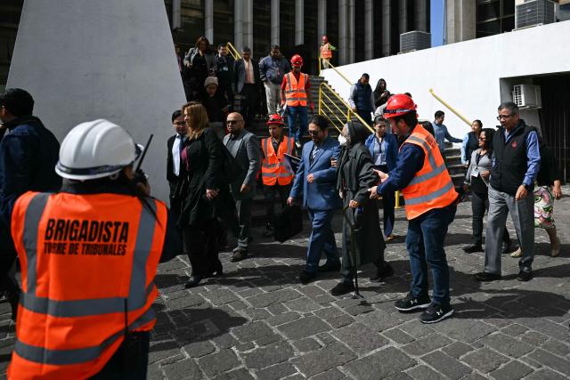 State workers help people during an earthquake drill in Guatemala City on February 24, 2026, in a commemoration of the 50th anniversary of the 1976 earthquake that killed 23,000 people. (Photo by JOHAN ORDONEZ / AFP)