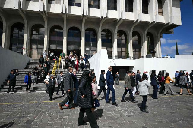 State workers take part in an earthquake drill in Guatemala City on February 24, 2026, during the 50th anniversary of the 1976 earthquake that killed 23,000 people. (Photo by JOHAN ORDONEZ / AFP)