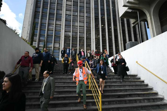 State workers take part in an earthquake drill in Guatemala City on February 24, 2026, during the 50th anniversary of the 1976 earthquake that killed 23,000 people. (Photo by JOHAN ORDONEZ / AFP)