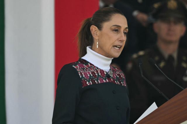 Mexico’s President Claudia Sheinbaum delivers a speech during the celebration of Flag Day in Mexico City on February 24, 2026. Sheinbaum offered "full guarantees" for the safety of football fans at World Cup games in the violence-plagued city of Guadalajara on February 24. (Photo by YURI CORTEZ / AFP)