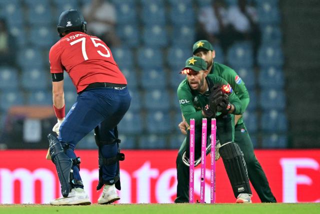 England's Jamie Overton (L) is stumped out by Pakistan's wicketkeeper Usman Khan (C) during the 2026 ICC Men's T20 Cricket World Cup Super Eights match between England and Pakistan at the Pallekele International Cricket Stadium in Kandy on February 24, 2026. (Photo by Ishara S. KODIKARA / AFP)