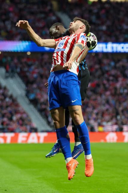 Club Brugge's Portuguese forward #09 Carlos Forbs (L) goes for a header with Atletico Madrid's Italian defender #03 Matteo Ruggeri during the UEFA Champions League knockout round play-off second leg football match between Club Atletico de Madrid and Club Brugge KV at Metropolitano Stadium in Madrid on February 24, 2026. (Photo by Pierre-Philippe MARCOU / AFP)