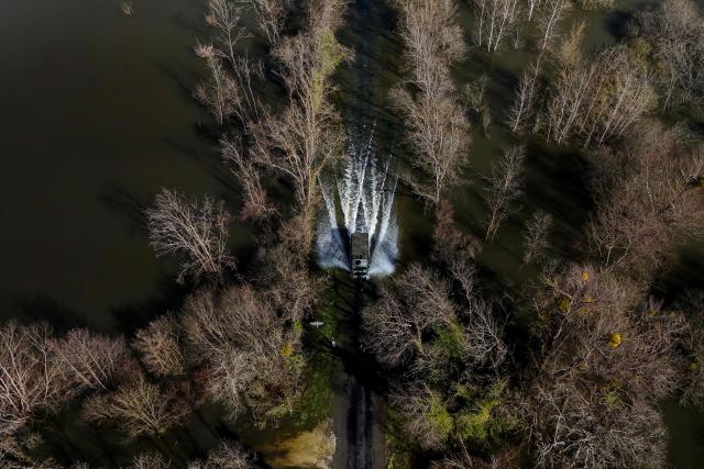 This aerial picture shows a French gendarmerie 4x4 vehicle transporting residents making its way through a flooded from the flood-isolated village of Courcoury towards neighboring Courpignac on February 24, 2026, as the Charente-Maritime commune in south-western France remains surrounded by floodwaters following storm Nils. (Photo by Christophe ARCHAMBAULT / AFP)