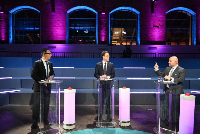 (L-R) The top candidates for the upcoming state elections in Baden-Wuerttemberg of the Greens Cem Oezdemir ,of the Christian Democratic Union (CDU), Manuel Hagel, and of the  far-right Alternative for Germany (AFD), Markus Frohnmaier, wait for the start of a live tv-debate in Stuttgart, southern Germany, on February 24, 2026. State elections are set to take place on March 8, 2026 in Baden-Wuerttemberg. (Photo by THOMAS KIENZLE / AFP)