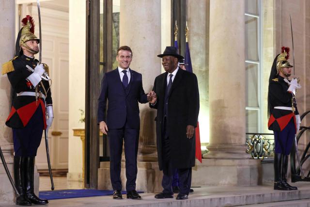 France's President Emmanuel Macron (CL) welcomes Ivory Coast's President Alassane Ouattara (CR) ahead of a meeting at The Elysee Presidential Palace in Paris on February 24, 2026. (Photo by Ludovic MARIN / AFP)