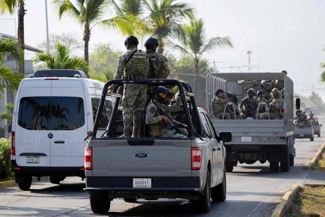 Members of the Mexican Navy patrol the streets of Puerto Vallarta, Jalisco state, Mexico on February 24, 2026. Puerto Vallarta is known as a paradise, but after the cartel violence on February 22, 2026, following the death of ‘El Mencho’, this Pacific resort city looks more like a war zone, with dozens of burned vehicles and vandalized shops. (Photo by Alfredo ESTRELLA / AFP)