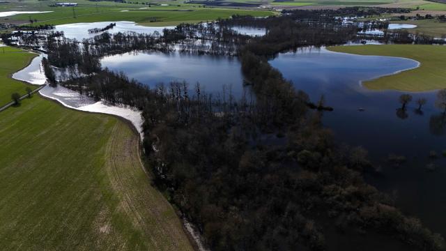 This aerial photograph shows flood waters spreading over fields near Courpignac, south-western France, after both the Charente and Seugne rivers overflew, on February 24, 2026. (Photo by Christophe ARCHAMBAULT / AFP)