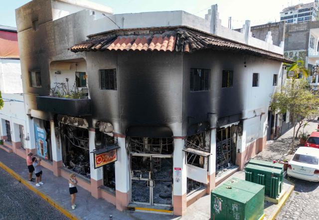 Aerial view of a burned shop in Puerto Vallarta, Jalisco State, Mexico, on February 24, 2026. Puerto Vallarta is known as a paradise. But following the narco chaos on February 22 following the death of the druglord "El Mencho," the tourist destination seems more like a war-zone, where dozens of incinerated vehicles line the streets and vandalized stores remain empty. (Photo by Alfredo ESTRELLA / AFP)