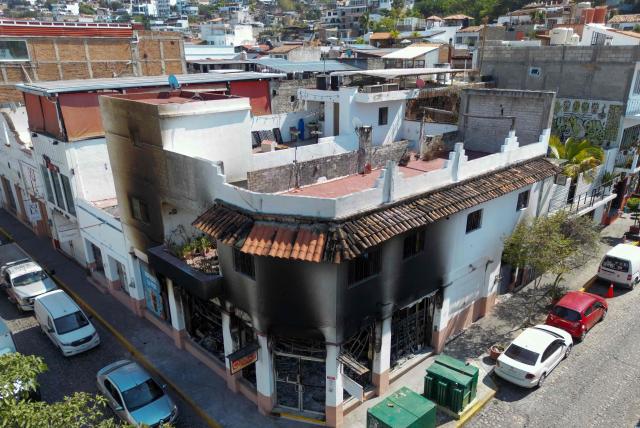 Aerial view of a burned shop in Puerto Vallarta, Jalisco State, Mexico, on February 24, 2026. Puerto Vallarta is known as a paradise. But following the narco chaos on February 22 following the death of the druglord "El Mencho," the tourist destination seems more like a war-zone, where dozens of incinerated vehicles line the streets and vandalized stores remain empty. (Photo by Alfredo ESTRELLA / AFP)