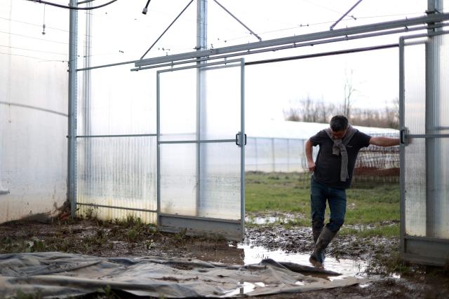 Symeon Gurnade, a market gardener, reacts as he looks at his vegetable plants destroyed by flooding in Baurech southwestern France, on February 24, 2026. National weather service Meteo-France said on February 18, 2026 the country was experiencing its longest series of rainy days since measurements began in 1959, breaking the 2023 record. Four departments in western France were placed under red alert over the risk of flooding, with officials expecting the situation to worsen with the arrival of Storm Pedro, which is poised to batter swathes of western Europe (Photo by ROMAIN PERROCHEAU / AFP)