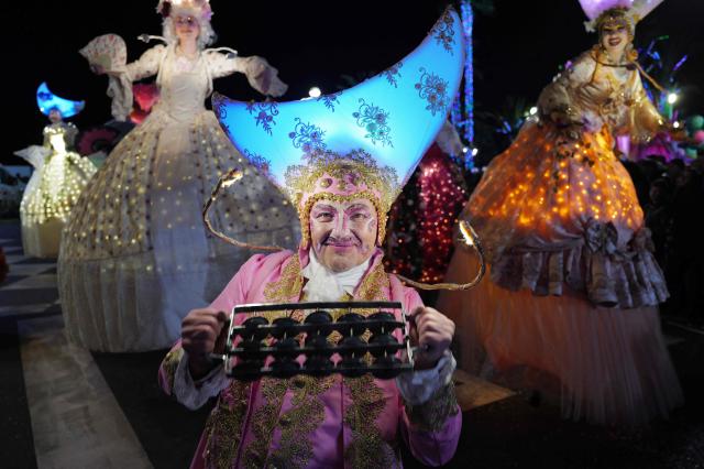 Artists perform during the 141th edition of the Nice Carnival in the French Riviera City of Nice on February 24, 2026. The edition 2026 of the Nice Carnival, whose theme is "Long live the Queen", takes place until March 1, 2026. (Photo by Valery HACHE / AFP)