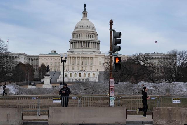 Members of the US Capitol police stand near security fencing along the perimeter of the US Capitol ahead of tonight's State of the Union address by US President Donald Trump in Washington, DC, on February 24, 2026. (Photo by Ken CEDENO / AFP)