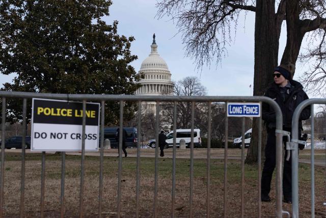 Members of the US Capitol police stand near security fencing along the perimeter of the US Capitol ahead of tonight's State of the Union address by US President Donald Trump in Washington, DC, on February 24, 2026. (Photo by Ken CEDENO / AFP)