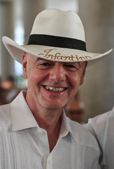 FIFA President Gianni Infantino wears a typical Colombian hat reading ‘Infantino’ during his visit to the new Concentration Hotel of the Colombian Football Federation, in Barranquilla on February 24, 2026. FIFA boss Gianni Infantino told AFP on Tuesday he was "very reassured" about Mexico's hosting of games in the World Cup, in his first comments on the violence triggered by the killing of a drug cartel leader. (Photo by David SALAZAR / AFP)