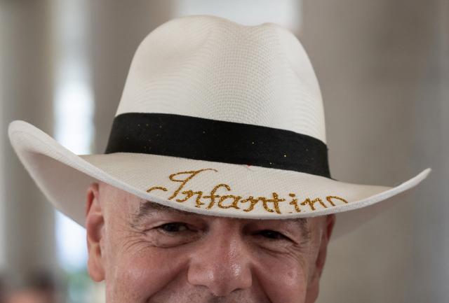TOPSHOT - FIFA President Gianni Infantino wears a typical Colombian hat reading ‘Infantino’ during his visit to the new Concentration Hotel of the Colombian Football Federation, in Barranquilla on February 24, 2026. FIFA boss Gianni Infantino told AFP on Tuesday he was "very reassured" about Mexico's hosting of games in the World Cup, in his first comments on the violence triggered by the killing of a drug cartel leader. (Photo by David SALAZAR / AFP)
