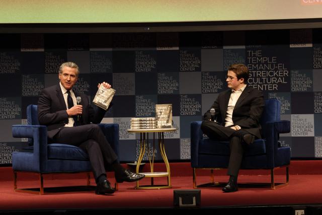 California Governor Gavin Newsom speaks with Harry Sisson to promote his book, "Young Man in a Hurry" at the Streicker Cultural Center, in New York, on February 24, 2026. (Photo by TIMOTHY A. CLARY / AFP)